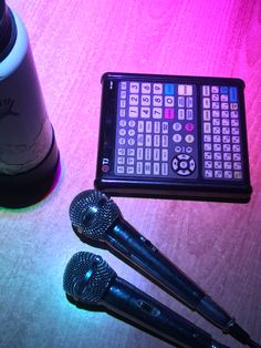 two microphones and a remote control on a table