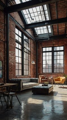 an industrial living room with exposed brick walls and floor to ceiling windows that overlook the city