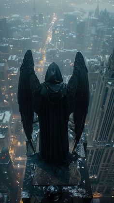 an angel statue on top of a building in the city