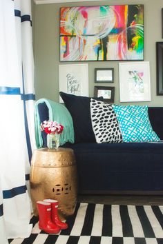 a living room filled with furniture and pictures on the wall