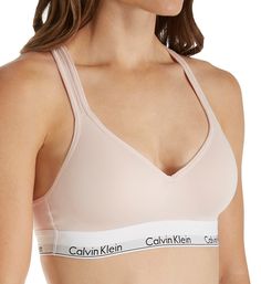 Highly sought after, highly comfortable bra with instantly recognizable Calvin Klein logos and push-up padding for a flattering lift. Made of cotton, modal, polyester and elastane. Wireless, contour/t-shirt cup has a medium graduated push-up bump ridge along bottom and side for enhanced cleavage. Cotton-blend cup overlay has a soft, smooth finish. Flattering neckline with a tall center front. Exposed elastic Calvin Klein underband secures fit and lends light support. Sides and back are self-line Calvin Klein Seamless Sports Bra With Medium Support, Calvin Klein Medium Support Seamless Sports Bra, Calvin Klein Stretch Seamless Sports Bra, Fitted Seamless Calvin Klein Bra, Calvin Klein Seamless Fitted Bra, Calvin Klein Fitted Seamless Bra, Calvin Klein Seamless Bra, Calvin Klein Underwire Bra With Padded Cups, Medium Support Push-up Sports Bra