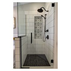 a walk in shower with black and white tile