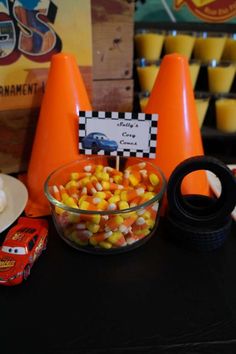 a table topped with candy corn and orange cones