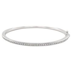 Elevate your elegance with this exquisitely made oval bangle crafted from luxurious 18k white gold. The sleek, contemporary design is adorned with a shimmering array of natural diamonds, which are meticulously set to enhance their brilliance. The oval shape ensures a sophisticated, graceful fit on the wrist, making it a versatile piece that transitions effortlessly from day to night. 18k White Gold Diamonds - .72 cts Oval Bangle, Slim Aarons, Diamond Bangle, White Gold Diamonds, Natural Diamonds, Contemporary Design, Bangle Bracelets, Jewelry Bracelets, Bangles