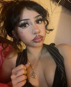 a woman with piercings on her nose posing for the camera