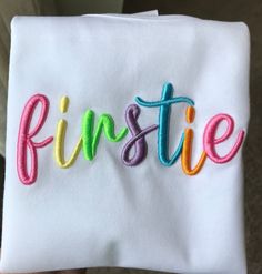 a white towel with the word inspire written in multicolored letters on it's side