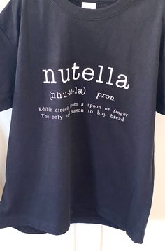 This is a fun T-shirt for all children (& some adults I know). Who doesn't like Nutella after all (there are other chocolate spreads available!)  This is a black 100% cotton T-shirt which will keep you nice and cool when the hotter weather arrives. It's available for children from 12 months up. Nutella T Shirt, Nerd Jokes, Slogan T Shirt, Kids Graphic Tees, Hot Weather, Spreads, Nutella, Cool T Shirts, 12 Months