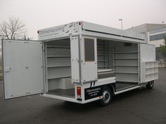 a small white truck parked in a parking lot