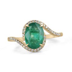 A beautiful, oval emerald and diamond ladies' ring. The center gemstone features a lovely 1.65-carat, natural oval-cut emerald with remarkable qualities. Carefully prong set, with micro-pave set diamonds accenting the bypass shank. Crafted in gleaming 14K yellow gold. Setting Style: Prong/Pave Setting Material: 14K Yellow Gold Setting Weight: 2.3 Grams Main Stone: Emerald Shape: Oval Cut Weight: 1.65-Carats Clarity: Semi-Transparent Color: Lush Dark Green Luster: Good Treatments: Natural, Oiling Origin: Zambia Secondary Stone: Diamond Weight: 0.15-Carats (Total) Cut: Round Clarity: VS Color: H Luster: Excellent Treatments: Natural Estimated Retail Value: $6,490.00 USD A certificate of appraisal is provided upon purchase. Keep in mind we custom create all of the items listed here. If you ha Oval Emerald Birthstone Ring In Fine Jewelry Style, Exquisite Oval Emerald Ring, Oval Emerald Gemstones With Halo Setting, Oval Green Diamond Gemstones, Oval Yellow Gold Gemstones With Halo Setting, Oval Emerald Gemstone Ring Fine Jewelry, Exquisite Oval Emerald Ring With Accent Stones, Oval Emerald Gemstones For Wedding, Oval Emerald Wedding Gemstones