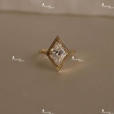 a diamond ring sitting on top of a table