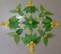 some yellow flowers and green leaves on a table