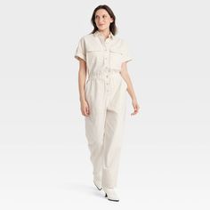 Elevate your wardrobe with this Boilersuit from Universal Thread™. Made from recycled cotton with added spandex, this boilersuit features relaxed-fit legs and an ankle length. The boilersuit comes in a short-sleeve design with a collared neckline and boasts multiple pockets for practicality. The elastic waistband and front buttons add extra flair for an on-trend look. Universal Thread™: Found exclusively at Target. Cotton Overall Jumpsuits For Loungewear, Cotton Loungewear Jumpsuit Overall, Cotton Loungewear Overalls, Cotton Jumpsuit For Loungewear, Short Sleeve Cotton Overalls For Workwear, Casual Cotton Jumpsuits And Rompers For Work, Cotton Utility Jumpsuit With Short Sleeves, Cotton Utility Jumpsuits And Rompers With Short Sleeve, Cotton Utility Jumpsuit With Relaxed Fit