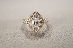 I am offering you this vintage sterling silver band ring. This ring features 5 total combination round and oval shaped prong set genuine aquamarine and diamond stones, set in a fabulous victorian style multi stone etched filigree halo setting. It is currently a size 11. though I am sure this could be sized up or down. It measures app. 3/4 inch. It weighs app. 5.5 grams.   Please review all of my pictures, as they are a very important part of my listing / descriptions.  This is coming to you fres Diamond White Oval Topaz Wedding Ring, Oval Diamond White Topaz Ring For Wedding, Oval Diamond White Topaz Wedding Ring, Vintage White Rings With Accent Stones, Vintage Silver Topaz Ring With Diamond Cut, Heirloom Silver Topaz Ring With Diamond Cut, Elegant Silver Pear-shaped Topaz Ring, Oval White Topaz Wedding Rings, Vintage Silver Ring With Marquise Cut