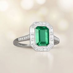 A Lively Halo Engagement Ring Featuring A 1.54 Carat Emerald-Cut Natural Green Emerald. Emerald And Diamond Ring Vintage, Emerald Ring With Halo Setting In Platinum, Green Emerald Ring With Halo Setting In Platinum, Green Emerald Platinum Ring With Halo Setting, Green Emerald Cut Halo Ring In Platinum, Green Emerald-cut Platinum Halo Ring, Platinum Emerald Ring With Baguette Cut And Halo Setting, Baguette Cut Emerald Ring With Halo Setting In Platinum, Emerald Cut Emerald Ring With Halo