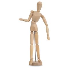 a wooden mannequin standing with its arms out and pointing to the side on a white background