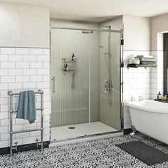 a white bath tub sitting next to a walk in shower