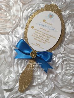 a wedding card with a blue ribbon and a gold key attached to the front of it