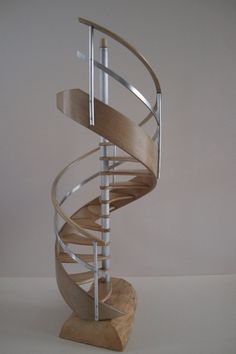 a spiral staircase made out of wood and metal