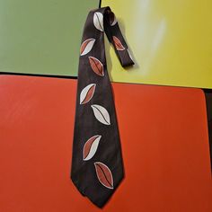 Burdines  Fab 1940's mens wide swing tie. Art deco graphics on 100% silk. Chocolate brown background with geo leaf print. Please check below for actual measurements.           Wide 4''  Length 51'' Condition: Looks like a snag to lining (see photo). Tie Art, Fashion Eras, Art Deco Graphics, Silk Chocolate, Band Art, Vintage 40s, Brown Background, Geo Print, Tie Accessories