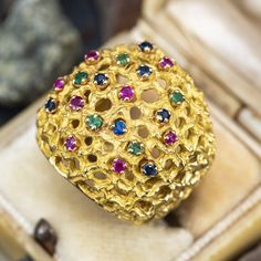 This striking circa 1970s ring features an organic design with open work details and is prong set with eight (8) round mixed cut rubies, five (5) round mixed cut emeralds and seven (7) round mixed cut sapphires. The ring measures 20.9mm at the top, rises 8.7mm above the finger, tapering to 7.0mm wide and 1.4mm thick at the base of the shank. This ring is currently a size 4.5. Multi Gemstone Ring, Vintage Cocktail Ring, Jewish Jewelry, Sparkly Things, November Birthstone, Organic Design, Emerald Stone, Sapphire Stone, Ruby Ring