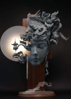 a sculpture of a woman's head is shown with the light behind it