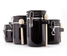 black jars with white handles and wooden spoons