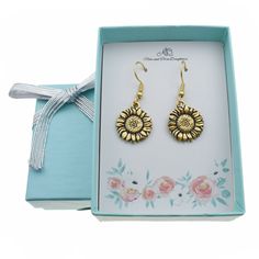 Our sunflower earrings are the perfect gift for any occasion! These earrings would make a wonderful Birthday, Christmas, Valentines Day, or anniversary gift for any special lady in your life! These cute earrings are made of 24K gold plated pewter on stainless steel wires. Stainless steel is a wonderful metal for earring wires because it is hypoallergenic and can be worn by most people. Size: one size.  Gender: female.  Age Group: adult. Metal Sunflower, Sunflower Charm, Sunflower Jewelry, Sunflower Gifts, Elastic Ribbon, Silver Ribbon, Sunflower Earrings, Earring Wires, Matching Jewelry