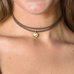 Step into the bohemian allure with our Western Simple Double Layered Heart Choker Necklace - a fusion of effortless style and free-spirited charm. 🌙✨ This trendy accessory boasts a minimalist design, featuring a double-layered choker adorned with a tiny silver heart charm, making it your perfect everyday statement piece. Customize your look with a choice of vegan cord colors, allowing you to express your individuality with every wear. Crafted with care, this necklace is made with hypoallergenic Adjustable Bohemian Heart Pendant Jewelry, Adjustable Gold Heart Choker Necklace, Adjustable Necklace For Valentine's Day Festival, Brown Bohemian Heart Necklaces, Brown Heart-shaped Bohemian Necklace, Bohemian Brown Heart-shaped Necklace, Festival Heart Beads Choker Jewelry, Heart Beads Choker For Festival, Heart Beads Festival Choker