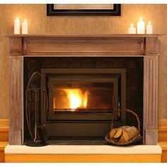 a fireplace with lit candles and a basket on the mantle