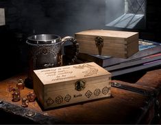 two wooden boxes sitting next to each other on top of a table with dices