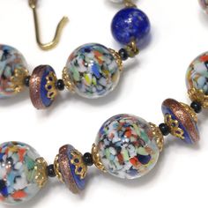 *Description: This is a beautiful vintage Murano glass beaded necklace with aventurine beads which look like glitter along the outside of this beautiful cobalt blue bead or within the bead. The larger 12mm beads are clear glass with multicolored specks of glass inside. Some of the extension beads are cobalt blue with aventurine glitter glass floating inside and others are clear glass with the multicolored glass inside. The combination of clear glass multicolored speckled beads and aventurine cob Vintage Murano Glass Necklace With Large Beads, Vintage Blue Glass Beaded Necklaces, Vintage Murano Glass Beaded Necklace With Large Beads, Vintage Blue Glass Beads, Vintage Murano Glass Beaded Necklaces, Vintage Glass Spacer Beads, Vintage Blue Glass Necklace, Vintage Blue Glass Jewelry, Vintage Murano Glass Jewelry For Jewelry Making