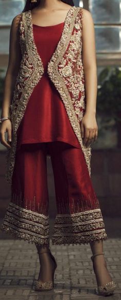 The gorgeous jacket style is an uplifting look for any formal occasion. Shining sequins, crystal and pearls are delicately placed by hand onto the silver tilla worked blooms. It is paired with a silk trouser with hand embellishments at the bottom.  Color: Red Includes: Shirt/Jacket Trouser Elegant Hand Embellished Raw Silk Sets, Elegant Raw Silk Sets With Sequins, Elegant Raw Silk Party Sets, Embellished Raw Silk Sets For Formal Occasions, Formal Embellished Raw Silk Sets, Luxury Embellished Party Sets, Elegant Embellished Raw Silk Sets, Elegant Silk Set With Mirror Work, Elegant Red Set With Mirror Work