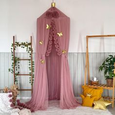 a pink canopy bed with butterflies on it