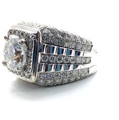 a white gold diamond ring with blue and white diamonds on the sides, set in 18k white gold