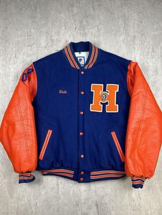 This vintage Hershey High School Trojans Football varsity letter jacket is a classic piece of high school memorabilia. In men's size 2XL, it features the Trojans' colors and emblem, showcasing a rich tradition of school pride. The letter jacket design offers a timeless look and is perfect for fans or alumni looking to celebrate their connection to Hershey High School. Please refer to the provided pictures for a detailed view of the condition and measurements of this item. We strive to present ou Varsity Team-colored Track Jacket For Sports, 1950s Varsity Jacket, College Varsity Team-colored Track Jacket, Blue Hooded Retro Varsity Jacket, Team-colored Varsity Outerwear For Sports, Letter Jacket, Trojans Football, Varsity Letter, School Pride