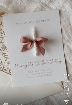 a card with a pink bow on it