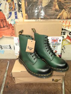 These Green Dr Martens boots are no longer in production. They are part of the Pascal range. This model has a sleeker toe box and suits those with a more slender foot. The upper has been finished in a Dark Green waxed leather with a black burnish running through it  These are a UK size 6, European 38, ladies USA 7 Fall High-top Boots With Rubber Toe Cap, Green High-top Lace-up Winter Boots, Green High-top Lace-up Boots For Winter, Green High-top Boots With Rubber Sole, Green Leather Waterproof Boots For Winter, Green Leather High-top Waterproof Boots, High-top Green Combat Boots For Fall, Green Boots With Reinforced Heel And Fitted Design, Green High-top Combat Boots For Fall