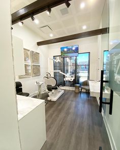 an empty salon with chairs and mirrors on the wall next to it's windows