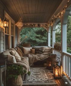 the porch is decorated with lights and pillows