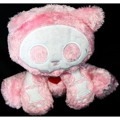 a pink and white teddy bear with big eyes