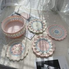 crocheted doily and plates on a table with an old photo in the background