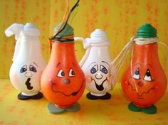 three orange vases with faces painted on them