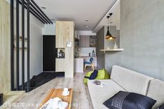 a living room filled with furniture next to a kitchen