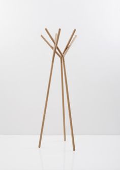 two wooden sticks sticking out of the ground next to each other on a white surface