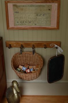 a basket filled with cubes sitting on top of a wooden floor next to a wall