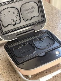 an open hello kitty pancake maker sitting on top of a counter