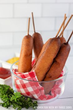 some food is in a glass bowl with toothpicks