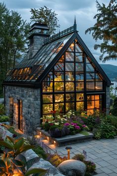 a house that is surrounded by plants and flowers