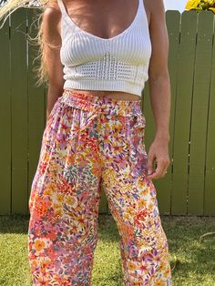 Ditch those boring trousers and upgrade to our Tulip Gardens beach pants! Featuring a flared leg and unique split tulip hem, these printed pants will have you turning heads. Made with 100% rayon for a comfortable and stylish fit. Get ready to stand out in these fun and playful pants! Summer Vacation Boho Print Bottoms, Summer Beach Boho Print Bottoms, Summer Floral Print Wide Leg Pants, Summer Floral Print Wide-leg Pants, Casual Boho Print Bottoms For Beach, Summer Wide Leg Pants With Floral Print, Summer Wide Leg Floral Print Pants, Floral Print Wide Leg Pants For Day Out, Bohemian Floral Print Bottoms For Vacation