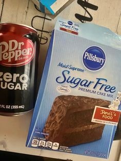 a can of sugar free cake next to a box of fudge